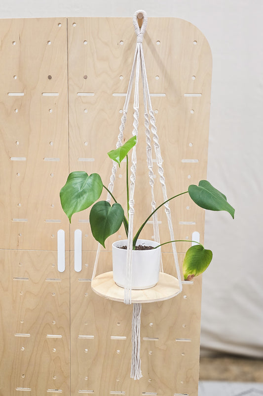 Macrame hanging planter with wood base.