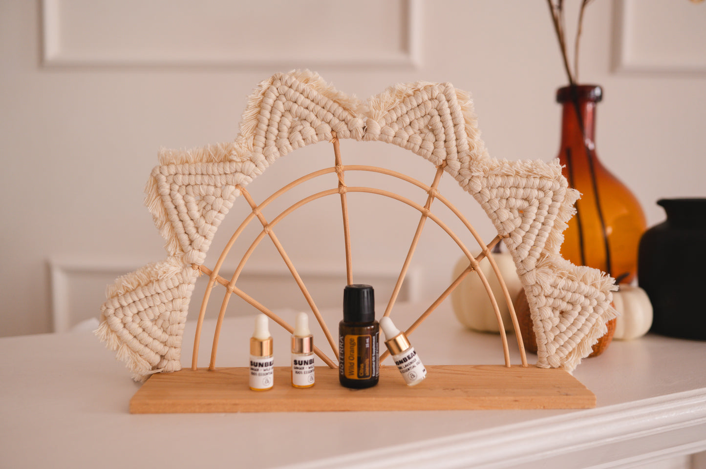 Decorative arch with small bottles on a shelf against a neutral background