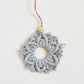 A ice blue color macrame snowflake ornaments on a white background