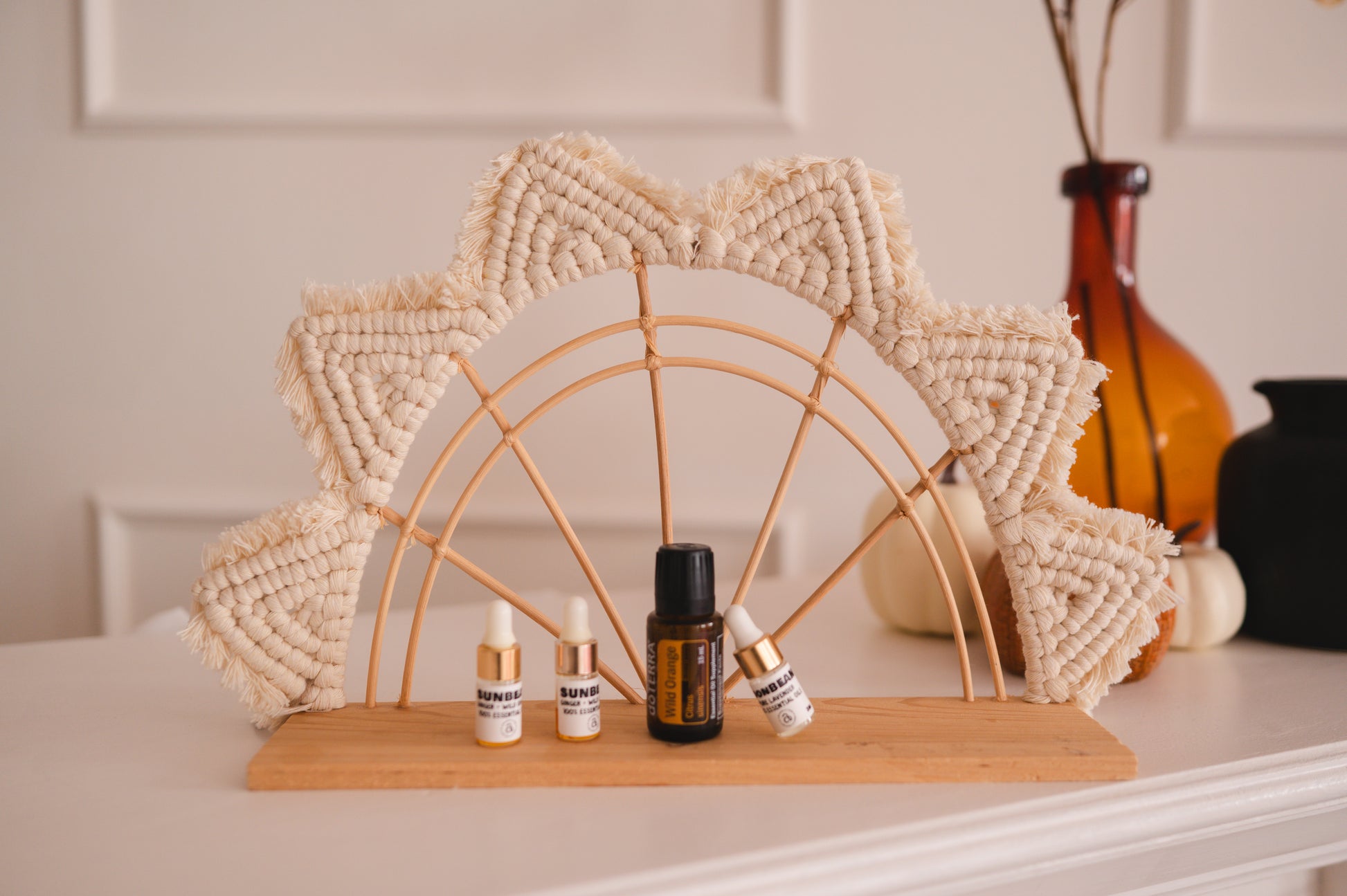 Decorative arch with small bottles on a shelf against a neutral background