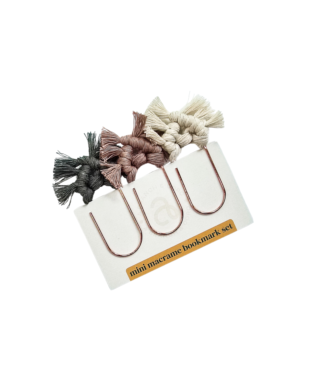 Set of mini macrame bookmark holders on a white background